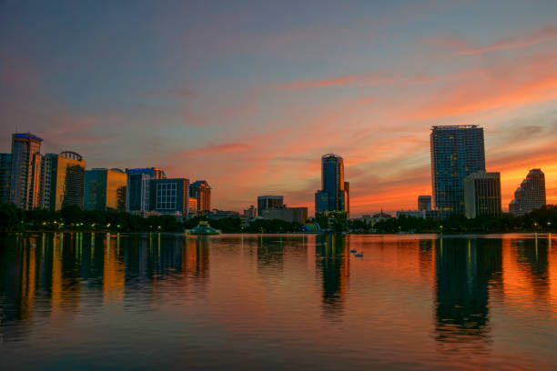 istock Orlando Florida Downtown Skyline During Vibrant Sunset Over Lake Eola 957884010