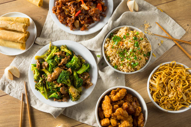 Spicy Chinese Take Out Food Spicy Chinese Take Out Food with Chopsticks and Fortune Cookies chinese cuisine fried rice asian cuisine wok stock pictures, royalty-free photos & images