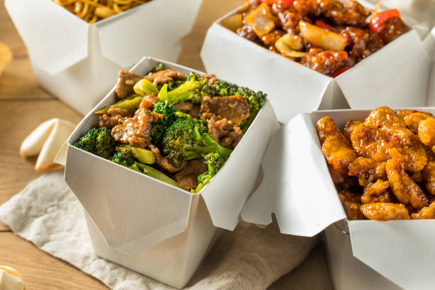 Spicy Chinese Take Out Food Spicy Chinese Take Out Food with Chopsticks and Fortune Cookies chinese food photos stock pictures, royalty-free photos & images