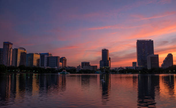 istock Orlando Florida Downtown Skyline During Vibrant Sunset Over Lake Eola 957884996