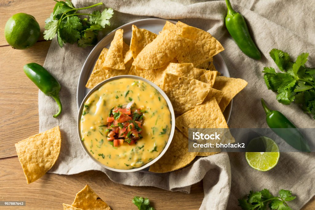 Spicy Homemade Cheesey Queso Dip Spicy Homemade Cheesey Queso Dip with Tortilla Chips Dipping Sauce Stock Photo