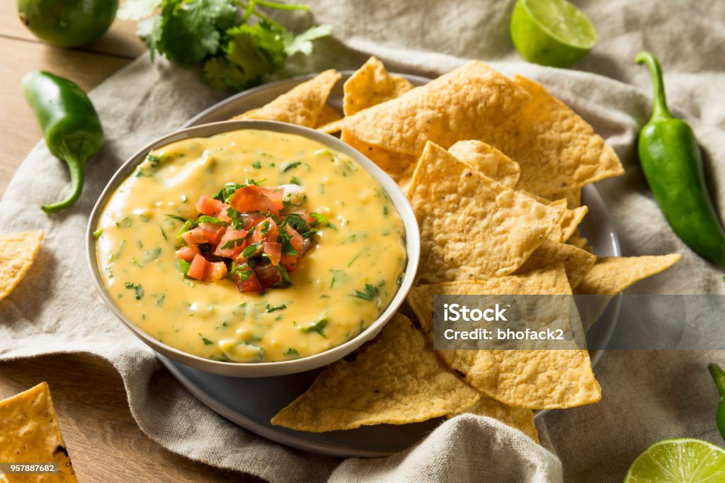 Spicy Homemade Cheesey Queso Dip Spicy Homemade Cheesey Queso Dip with Tortilla Chips Chile Con Queso Stock Photo