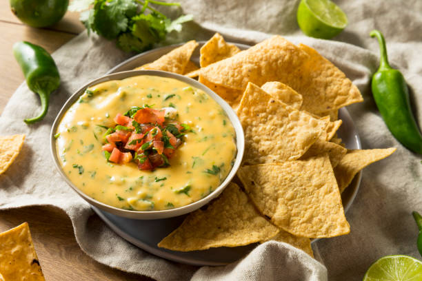 Spicy Homemade Cheesey Queso Dip Spicy Homemade Cheesey Queso Dip with Tortilla Chips cheese dip stock pictures, royalty-free photos & images