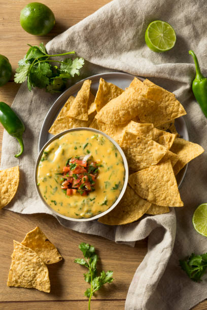 Spicy Homemade Cheesey Queso Dip Spicy Homemade Cheesey Queso Dip with Tortilla Chips cheese dip stock pictures, royalty-free photos & images