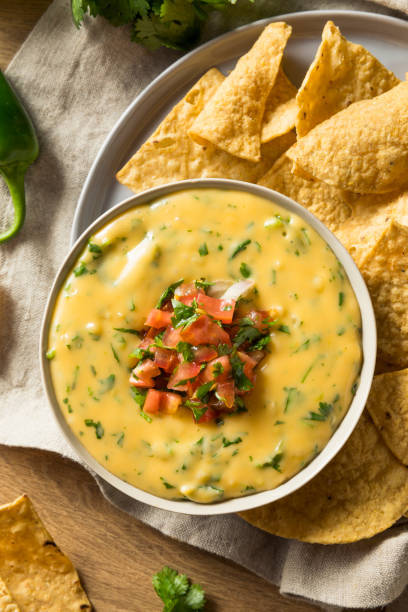 Spicy Homemade Cheesey Queso Dip Spicy Homemade Cheesey Queso Dip with Tortilla Chips cheese dip stock pictures, royalty-free photos & images