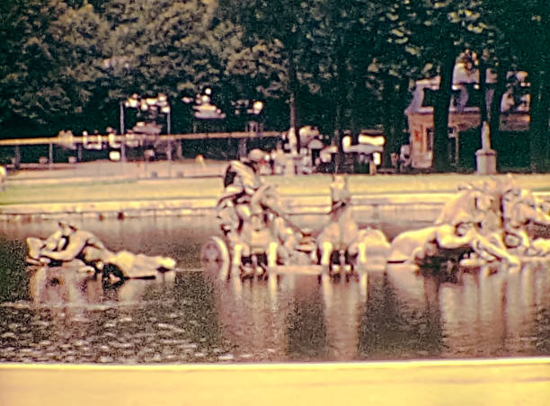 PARIS, FRANCE - CIRCA 1976: Tourists looking the Quadriga statue in the Apollo fountain at Palace of Versailles garden. Historic archival footage in Paris city of France in 1970s. PARIS in FRANCE, CIRCA 1976.