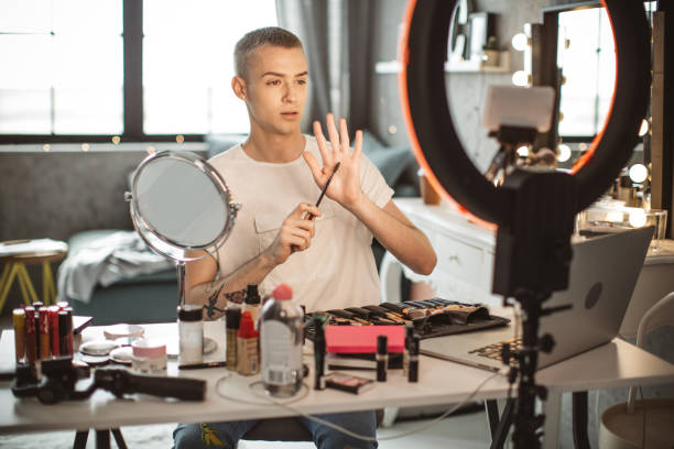istock Young male makeup artist 957896332