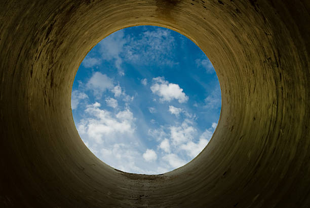 istock Upward view of the blue sky from a circular opening 95789846