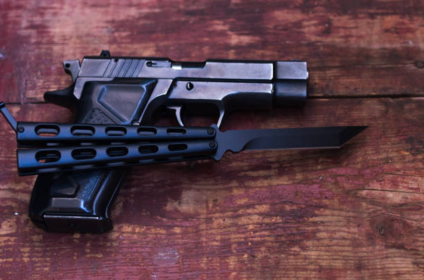 istock A knife and a gun. Vintage weapons. 957900374