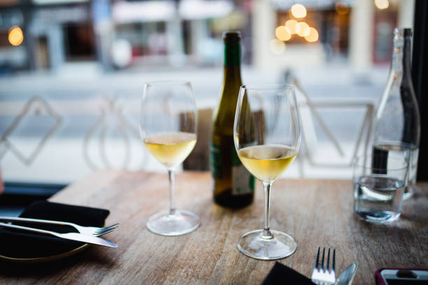 istock Two glasses of white wine in a restaurant 957900594