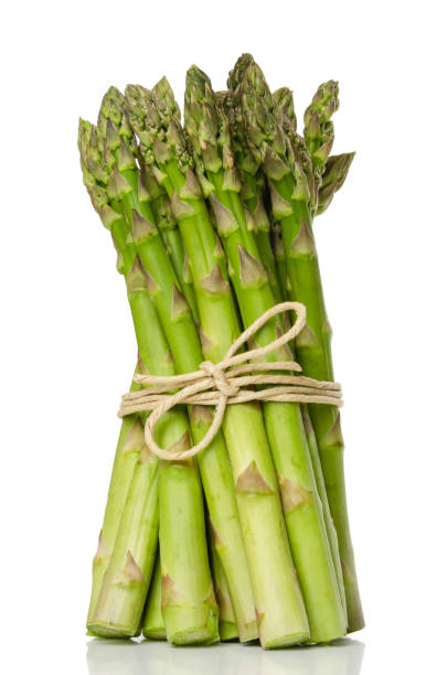 istock Bundle of green asparagus shoots, upright standing 957905600