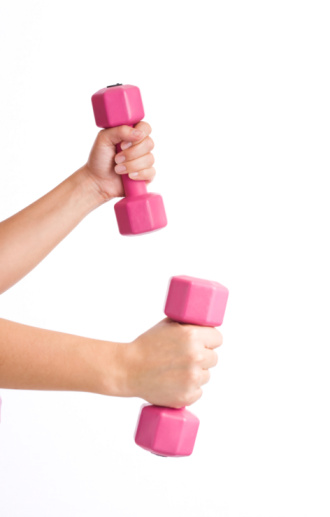 Woman hands lifting pink dumbbells, isolated on white background with copy space
