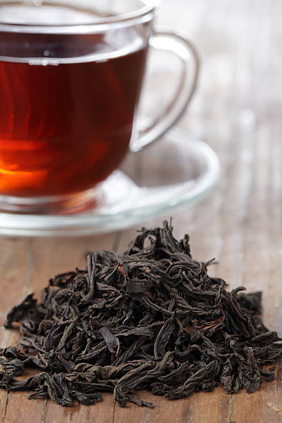 istock Black loose tea leaves with a cup of tea 95791979