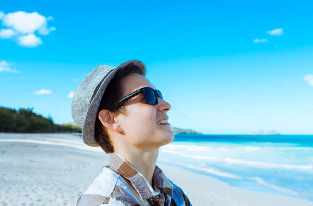 istock Young man enjoying day at the beach 957926714