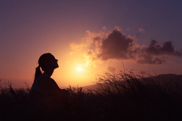 istock Woman enjoying beautiful sunset. 957926912