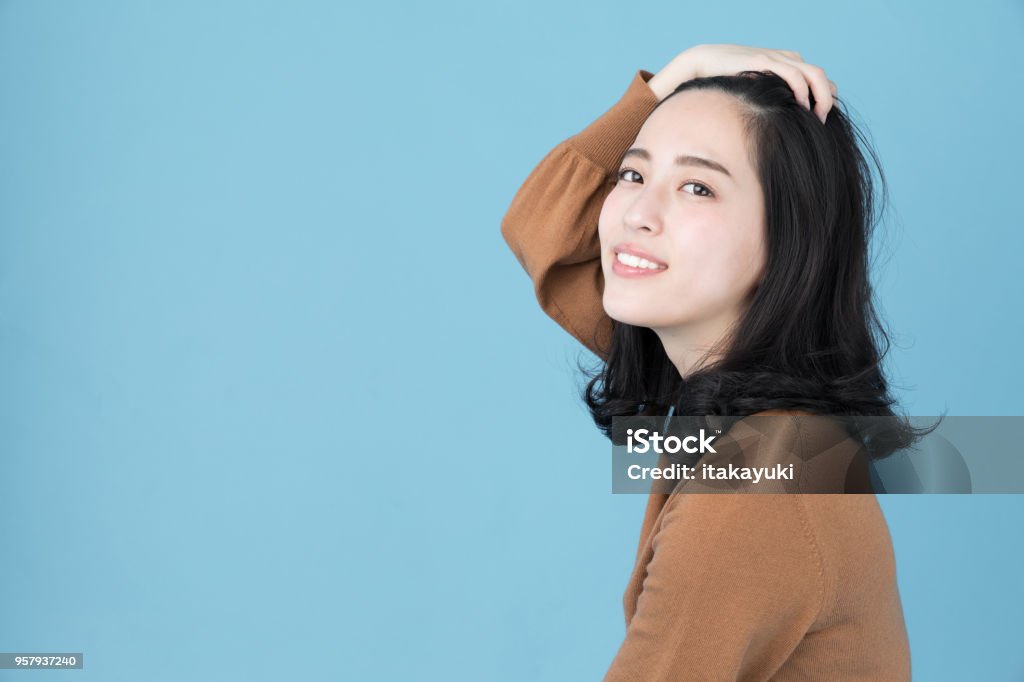 portrait of attractive asian woman isolated on blue background Hairstyle Stock Photo
