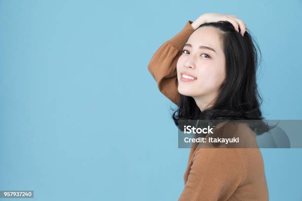 Portrait Of Attractive Asian Woman Isolated On Blue Background Stock Photo - Download Image Now