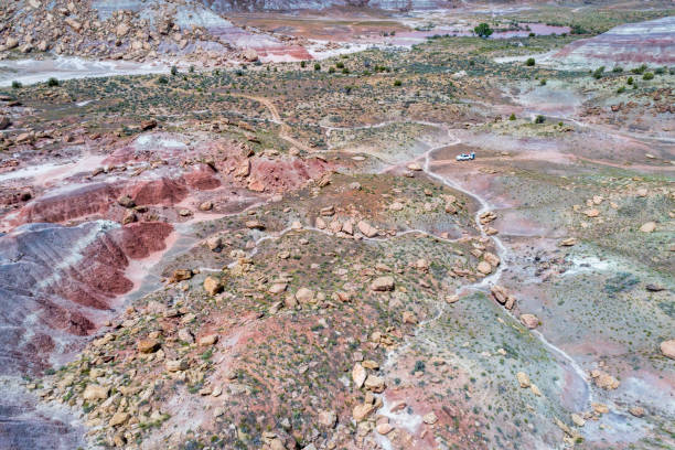 istock SUV car in rocky desert - aerial view 957940212