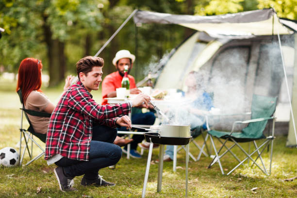 Group of young friends having a barbecue in a park