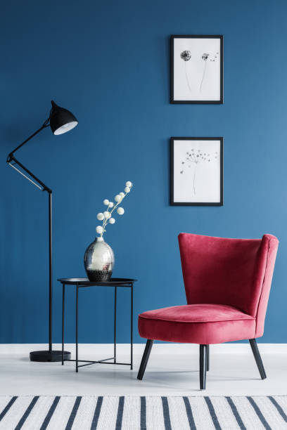 istock Red chair in blue interior 957956232