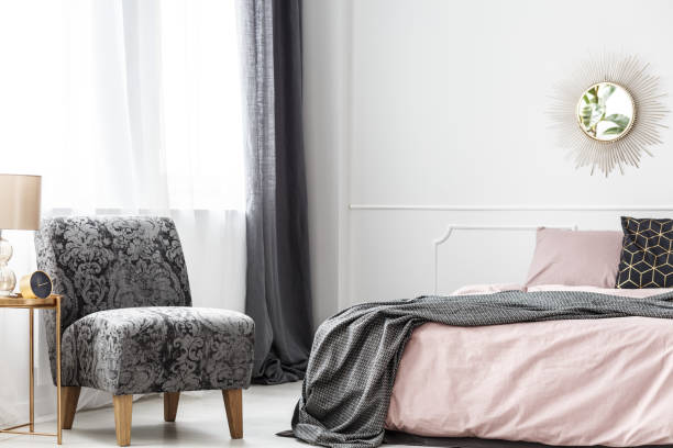 istock Minimalist hotel bedroom with armchair 957956416