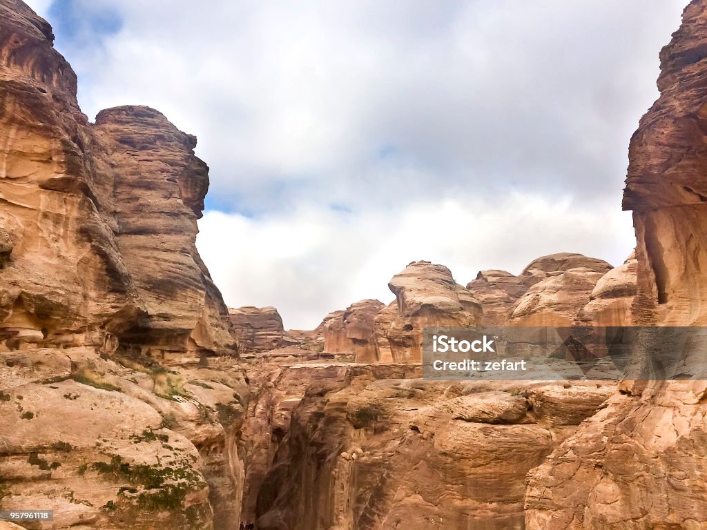 The rock in Siq Canyon, the narrow slot-canyon that serves as the entrance passage to the hidden city of Petra, Jordan, an UNESCO World Heritage Site Ancient Stock Photo