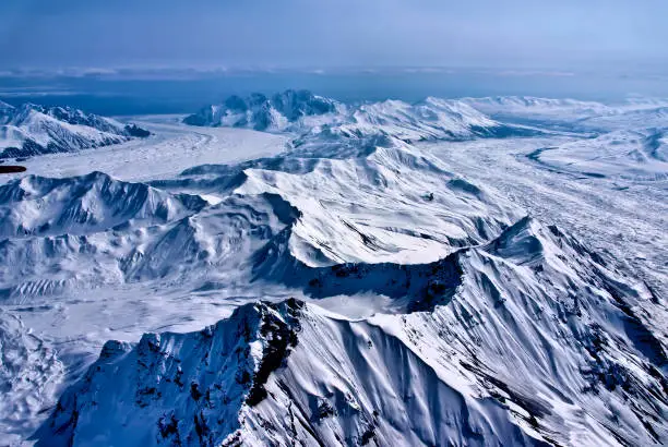 Aerial View of a River of Ice Flowing to the Sea.  The Beautiful Wind and Snow Sculpted Landscape of Denali National Park, Alaska.