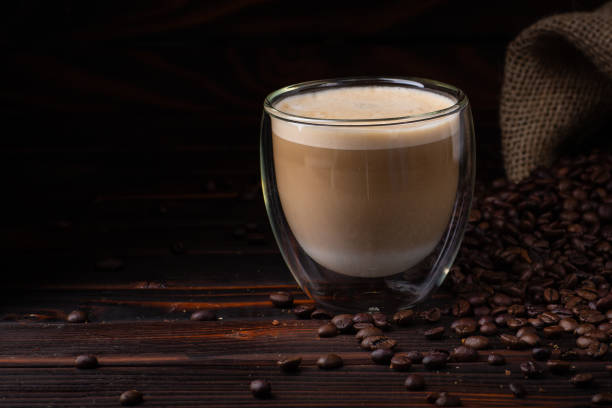 istock coffee latte and spilled coffee beans.  dark background 957976846