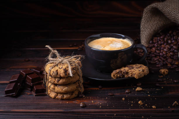 istock Coffee mood.dark background. coffee, cookies chocolate and crumbled coffee beans 957979404