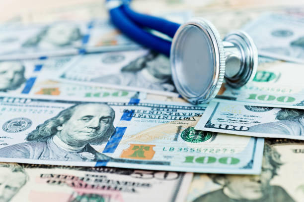 istock Stethoscope on top of US dollar bills 957980510