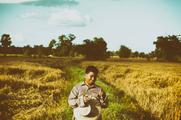 istock Brown Skin Farmer And His Rice Field 957982866