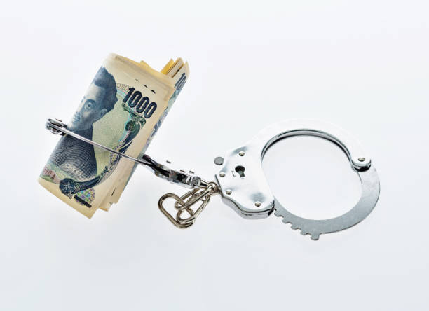 istock Japanese yen notes in handcuffs 957983756
