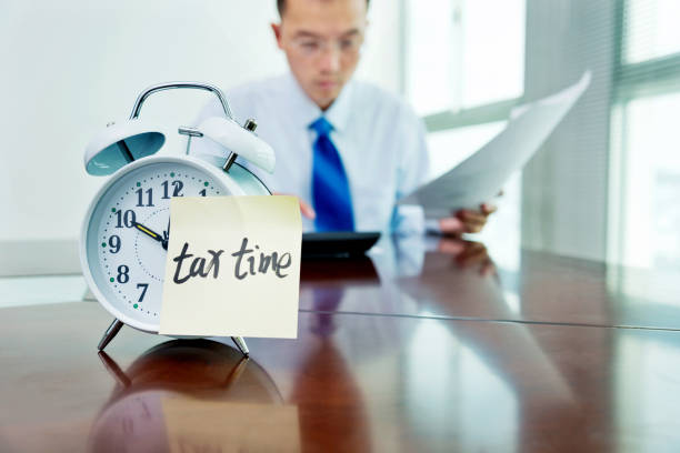 istock Man working on desk with an alarm clock 957986844