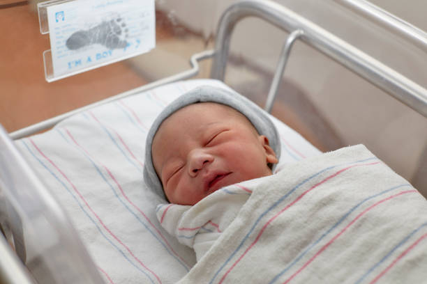 A New Born Infant in a Hospital Crib stock photo