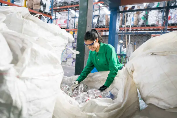 Photo of Woman working in a recycling factory
