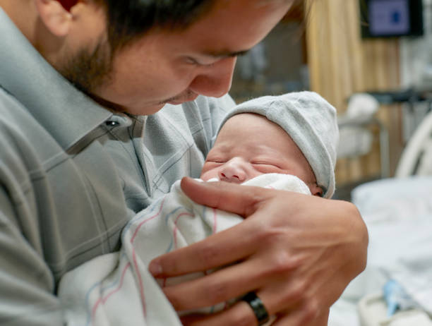 istock A Proud Father holding his Newborn Son 957987720