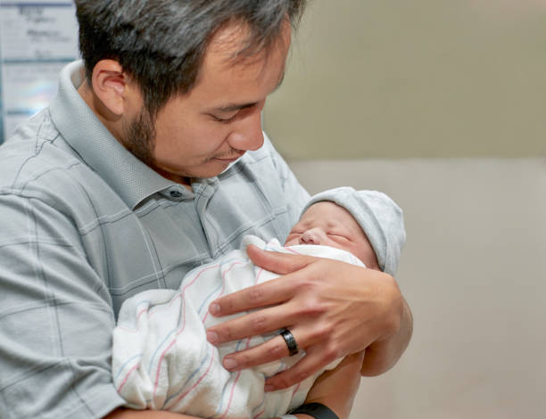 istock A Proud Father holding his Newborn Son 957987798