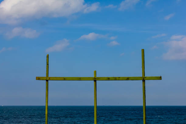a wooden stick structure used to dry fish caught in a beach village.
