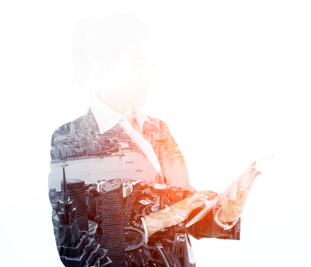 istock Multiple exposure of businesswoman using digital tablet 957990438