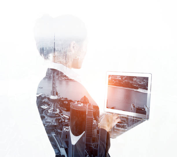 istock Multiple exposure of businesswoman using laptop 957990506