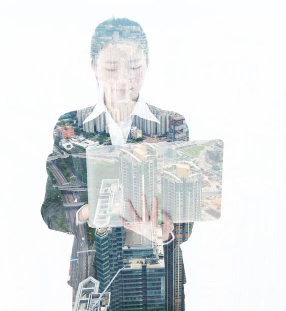 istock Multiple exposure of businesswoman using laptop 957990596
