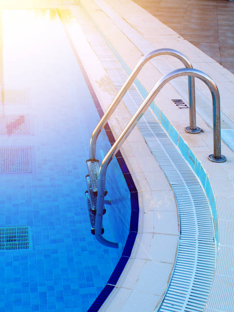istock swimming pool in-pool ladder and depth marker, sunlight effect toned 957994402