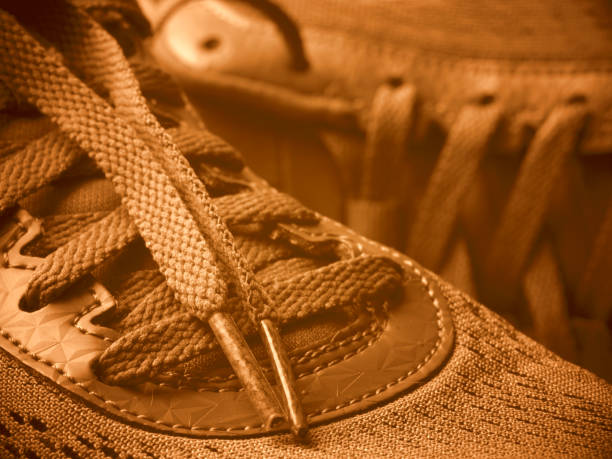istock sneakers laces closeup, toned in retro colors 957994680