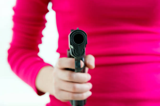 Woman hand holding a gun.