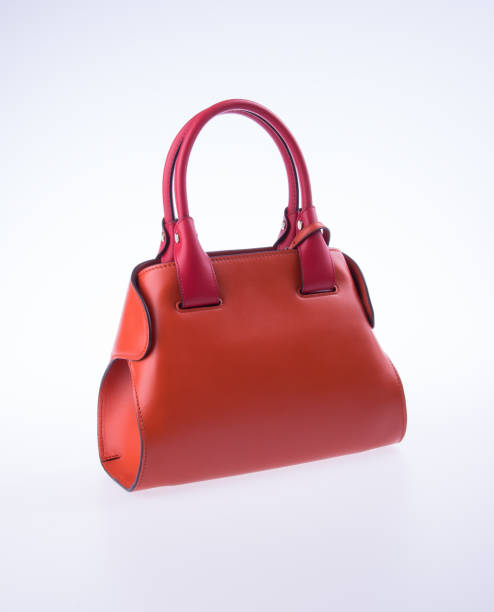 istock bag or brown leather woman handbag on background 957998894
