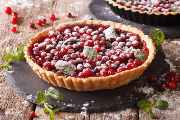 istock cranberry tart with jam, powdered sugar decorated with mint close up. horizontal 957999902