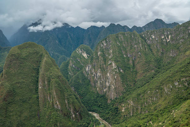 Clouds surrounding the Inca ruins and Machu Picchu during the day