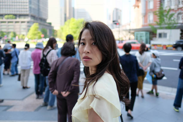 istock young woman waiting at crossing 958002694