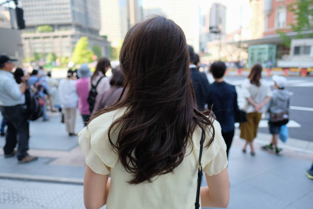 istock young woman waiting at crossing 958002720