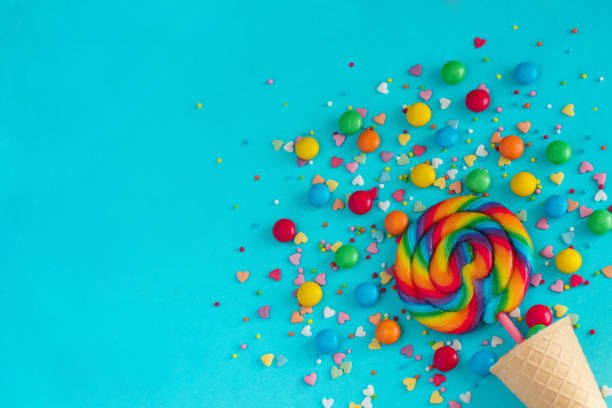 istock Ice cream cone with colorful lollipop and multicolored sweets, greeting card 958003970